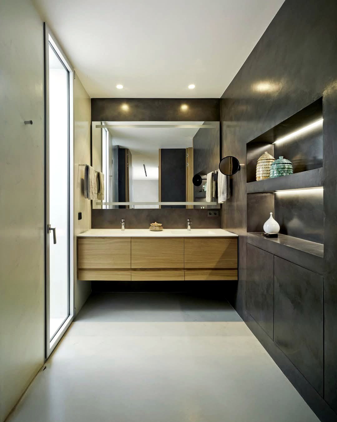 Dark charcoal microcement bathroom with floating double vanity and walk-in shower, installed by our team